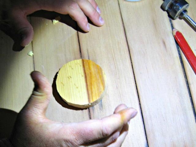 Placing the plug over the hole in our hardwood floor plug for hardwood floor restore repair