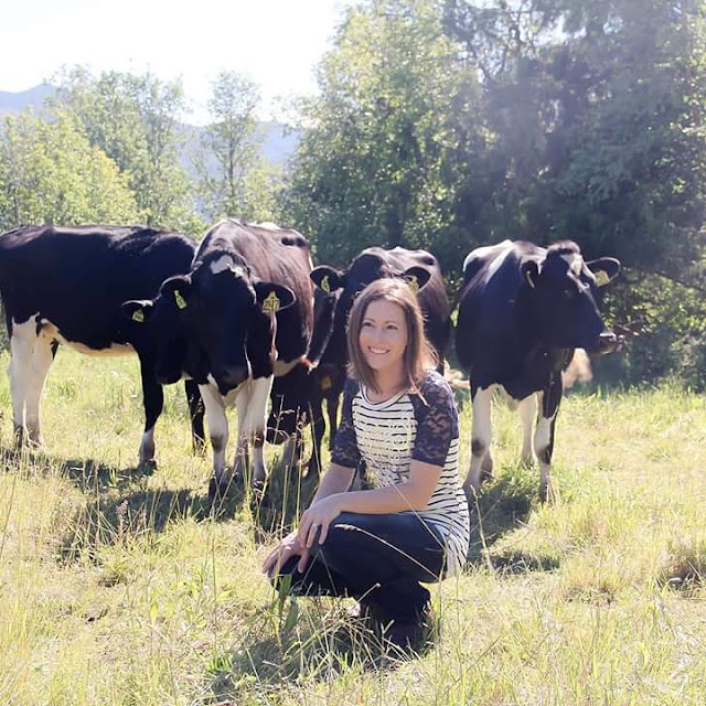 Krista Featured Farmer Dairy Farmer Dairy cattle grass woman near cows