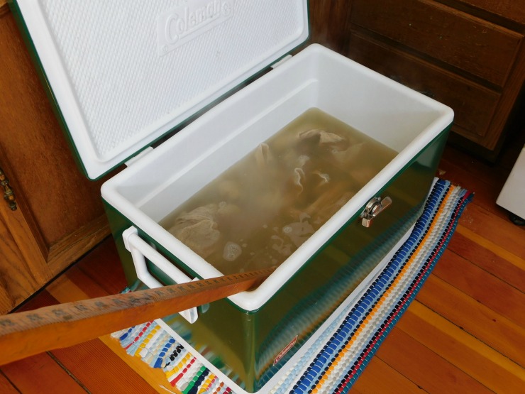 Scouring DIY Woven Baby Wrap using hot water and a cooler cooler filled with hot water to scour a homemade baby wrap carrier